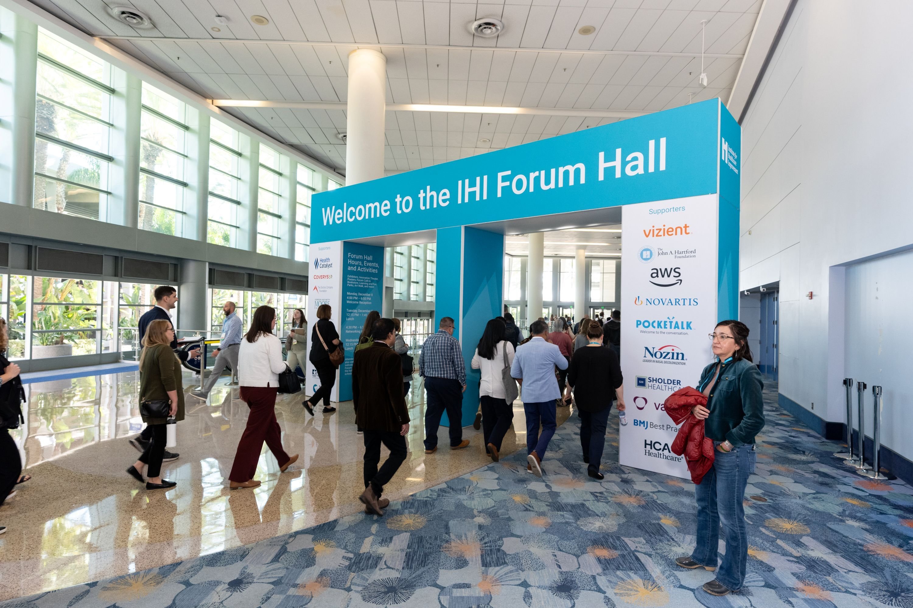 Attendees walking into the Forum Hall