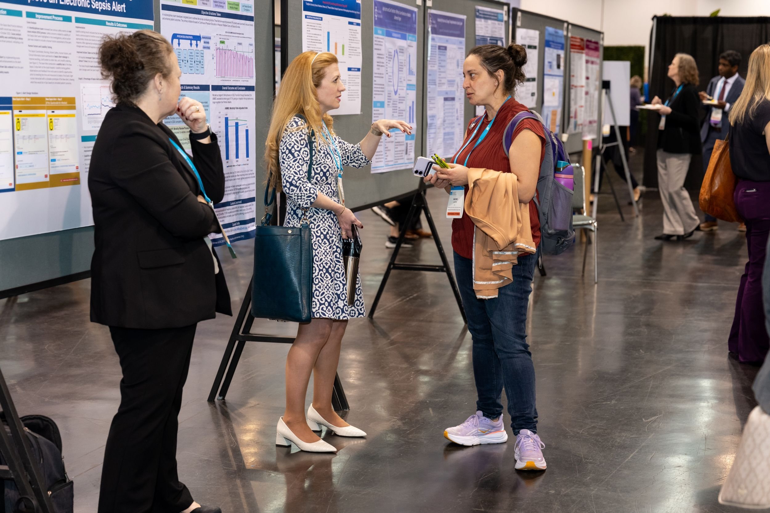 Forum 2025 poster presenter speaking with attendee