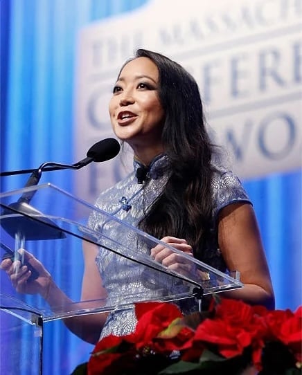 Candy Chang speaking onstage at a conference